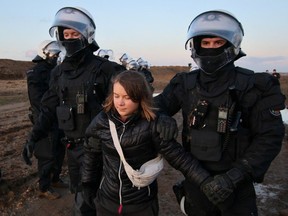 Police officers detain climate activist Greta Thunberg on the day of a protest against the expansion an open-cast mine in Germany, Jan. 17, 2023, that has highlighted tensions over Germany's climate policy during an energy crisis.