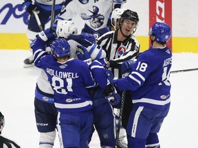 In this May 6, 2021 file photo, Toronto Marlies and Manitoba Moose grapple at centre ice during third period action in Toronto.