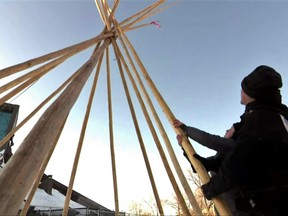 River Fontaine, left and Tory-Lynn Weir are seen building a tipi that was set up last week near the Circle of Life Thunderbird House in Winnipeg. Community activists are setting up temporary tipis on the streets of Winnipeg this winter, as they look to give the city’s unsheltered population more options to stay warm and stay safe. Handout