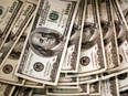 U.S. dollars are counted out by a banker counting currency at a bank in Westminster, Colo. Nov. 3, 2009.