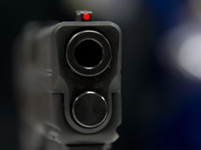 A view down the barrel of a semi-automatic handgun