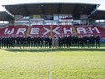 Britain's King Charles III and Camilla, the Queen Consort meet Wrexham Soccer team co owners, US actors Ryan Reynolds and Rob McElhenney and players during their visit to Wrexham Association Football Club's Racecourse Ground, in Wrexham, England, Friday, Dec. 9, 2022. The Hollywood owners of Wrexham are still learning the vernacular of British soccer. They don't need any advice, though, in setting the scene for this weekend's FA Cup match against second-division Sheffield United.