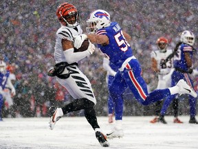 Cincinnati Bengals wide receiver Ja'Marr Chase (1) leaps fo a catch in the end zone as Buffalo Bills linebacker Matt Milano (58) defends in the second quarter during an NFL divisional playoff football game between the Cincinnati Bengals and the Buffalo Bills during an AFC divisional round game at Highmark Stadium in Orchard Park, N.Y., on Sunday, Jan. 22, 2023.