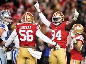 San Francisco 49ers defensive end Charles Omenihu (94) celebrates with San Francisco 49ers defensive end Samson Ebukam (56) after defeating the Dallas Cowboys 19-12 in a NFC divisional round game at Levi's Stadium in Santa Clara, Calif., on Jan 22, 2023.