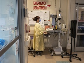 A healthcare worker is pictured In the Emergency Department at Toronto's Hospital for Sick Children on Nov. 30, 2022. Premiers and health ministers across the country have called on Ottawa to increase its share of health-care costs to 35 per cent, up from the current 22 per cent.