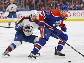 Edmonton Oilers forward Connor McDavid protects the puck against Colorado Avalanche forward Alex Newhook during the second periodat Rogers Place.