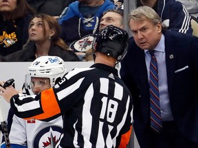 Winnipeg Jets head coach Rick Bowness (right) listens to referee Tom Chmielewski (18) during the second period against the Pittsburgh Penguins at PPG Paints Arena in Pittsburgh on Friday, Jan. 13, 2023.