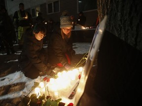 Kirstin Witwicki, right, a cousin of Morgan Harris, joined the family and friends of three slain women at a vigil in Winnipeg, Thursday, Dec. 1, 2022. A landfill has reopened to the public following weeks of conversations between the City of Winnipeg and demonstrators who set up blockades calling for a search of the area for Indigenous women believed to be victims of an alleged serial killer.