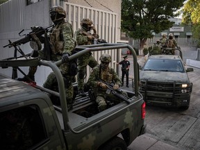 Armoured vehicles leave the Attorney General's Office for Special Investigations on Organized Crime (FEMDO) in Mexico City, on Jan. 5, 2023, after the arrest of Ovidio Guzman.