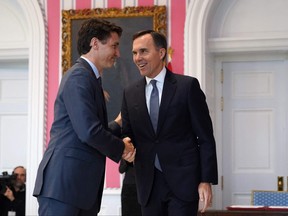 In this file photo, Prime Minister Justin Trudeau shakes hands with Minister of Finance Bill Morneau during a ceremony at Rideau Hall on Nov. 20, 2019 in Ottawa.