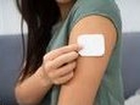 This is the most popular time of year to quit smoking. Above, a woman is shown applying a nicotine patch to her arm.
