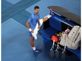 Australian Open - Melbourne Park, Melbourne, Australia - January 19, 2023. Serbia's Novak Djokovic stretches during his second round match against France's Enzo Couacaud.