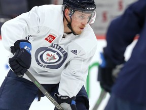 Nate Schmidt carries the puck at Winnipeg Jets practice on Wednesday, March 23, 2022.