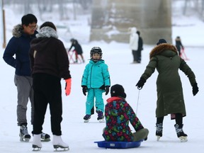Skaters on the first section of the Nestaweya River Trail, the Forks Port Rink, which opened in Winnipeg on Sunday, Jan. 1, 2023.