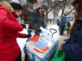 Marc Sweet (centre) and other members of Warmer Hearts Winnipeg give out hot soup and chili in the downtown area on Sunday, Jan. 14, 2023.