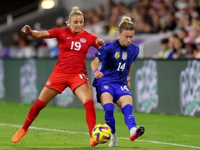Emily Sonnett #14 of the United States collides with Adriana Leon #19 of Canada during the second half in the 2023 SheBelieves Cup match at Exploria Stadium on February 16 in Orlando, Florida.