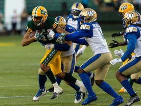 Edmonton Elks’ Kenny Lawler (89) is tackled by Winnipeg Blue Bombers’ Deatrick Nichols (1) during second half CFL football action at Commonwealth Stadium in Edmonton, on Friday, July 22, 2022. Photo by Ian Kucerak