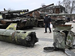 A man looks at destroyed Russian military vehicles and equipment shown in an open air exhibition in the centre of Kyiv on Feb. 24.