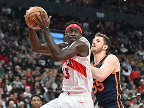 Raptors' Pascal Siakam takes in a rebound beside New York Knicks' Isaiah Hartenstein during the first half at Scotiabank Arena on Sunday, Jan. 22, 2023.