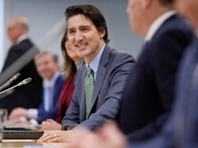 Prime Minister Justin Trudeau, with federal ministers and officials, takes part in a meeting with provincial and territorial premiers to discuss health care, in Ottawa, Feb. 7, 2023.