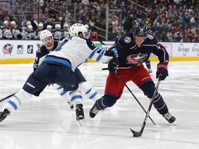 Feb 16, 2023; Columbus, Ohio, USA; Winnipeg Jets defenseman Neal Pionk (4) checks Columbus Blue Jackets right wing Patrik Laine (29) during the second period at Nationwide Arena. Mandatory Credit: Russell LaBounty-USA TODAY Sports