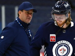 Kyle Connor (right) laughs at assistant coach Scott Arniel during Jets practice on Thursday. KEVIN KING/Winnipeg Sun