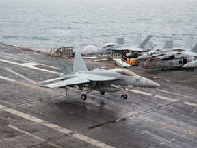 A F/A-18E Super Hornet fighter jet lands on the deck of the USS Nimitz Aircraft Carrier after a routine flight during a deployment to the South China Sea, Mid-Sea, Jan. 27, 2023.