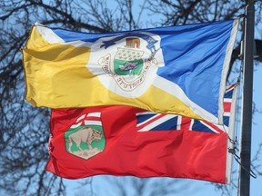 The City of Winnipeg's flag flies in front of Manitoba's Provincial flag, in Winnipeg.