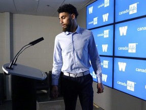 Free-agent receiver Kenny Lawler steps to the podium to address the media after signing a two-year contract to rejoin the Winnipeg Blue Bombers on Tuesday.