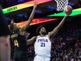 Philadelphia 76ers center Joel Embiid drives for a score past Cleveland Cavaliers forward Evan Mobley during the fourth quarter at Wells Fargo Center.