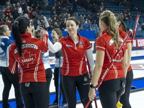 Kerri Einarson shakes hands with her teammates after a big win this week. Her team beat Northern Ontario's Krista McCarville to book a spot in Sunday night's final against fellow Manitoban Jennifer Jones.