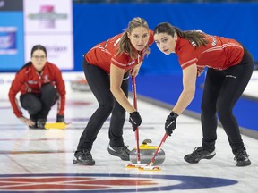 Kerri Einarson watches her shot as sweepers Briane Harris (left) and Shannon Birchard bring it to the house on Saturday in a win over Christina Black of Nova Scotia.