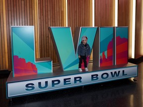 A young fan poses in front of a Super Bowl LVII sign during Super Bowl LVII Opening Night presented by Fast Twitch at Footprint Center on Feb. 6, 2023 in Phoenix, Ariz.