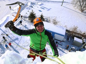 Michael Malets celebrates after climbing the St. Boniface Ice Tower during Festiglace, an annual ice climbing festival in Winnipeg, on Sunday, Feb. 5, 2023.