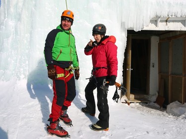 Michael Malets (left) learns about the belay system before climbing the St. Boniface Ice Tower during Festiglace, an annual ice climbing festival in Winnipeg, on Sunday, Feb. 5, 2023.