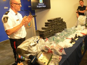 Insp. Elton Hall of the Winnipeg Police Organized Crime Division shows off the results of Project Onyx, a significant inter-provincial drug investigation that spanned Ontario and B.C. and resulted in the arrests of 13 individuals and the seizure of several luxury vehicles and 75 kilograms of cocaine, methamphetamine and MDMA worth more than $7 million at Winnipeg Police headquarters on Friday.
