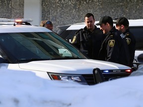 Police talk outside their vehicles after netting a suspect on Balmoral Street north of Ellice Avenue in Winnipeg on Sunday, Feb. 19, 2023. A police spokesman said there have been multiple reports of bear spray incidents in the West End and downtown areas on Sunday morning. They believe the incidents may be related and are searching for two males who are believed to be involved.