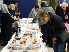 The perusing of goodies during a bake-sale fundraiser for earthquake victims in Turkey and Syria, at Waverley Heights Community Centre on Chancellor Drive in Winnipeg, on Monday, Feb. 20, 2023.