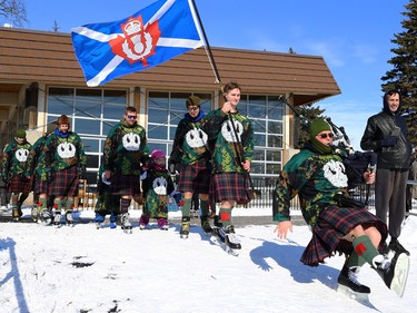 A piper from the Queen's Own Cameron Highlanders of Canada slips while leading members of the Camerons onto the ice for the Great Canadian Kilt Skate on the duck pond at Assiniboine Park in Winnipeg on Sunday, Feb. 26, 2023.