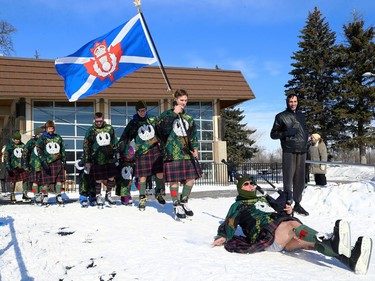 A piper from the Queen's Own Cameron Highlanders of Canada falls while leading members of the Camerons onto the ice for the Great Canadian Kilt Skate on the duck pond at Assiniboine Park in Winnipeg on Sunday, Feb. 26, 2023.