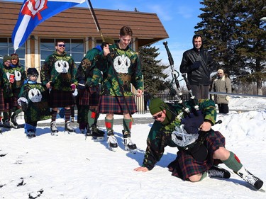 A piper from the Queen's Own Cameron Highlanders of Canada gets back up after falling while leading members of the Camerons onto the ice for the Great Canadian Kilt Skate on the duck pond at Assiniboine Park in Winnipeg on Sunday, Feb. 26, 2023.