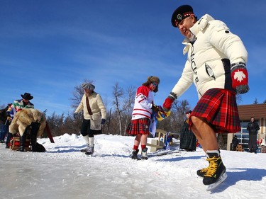 A sockless man steps onto the ice for the Great Canadian Kilt Skate on the duck pond at Assiniboine Park in Winnipeg on Sunday, Feb. 26, 2023.