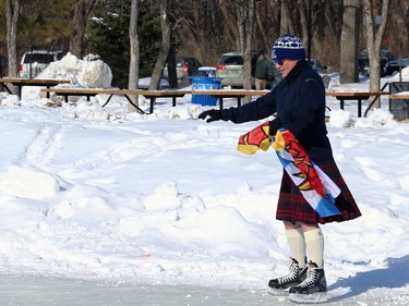 A man works to keep his balance during the Great Canadian Kilt Skate on the duck pond at Assiniboine Park in Winnipeg on Sunday, Feb. 26, 2023.