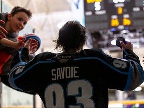 Matthew Savoie of the Winnipeg Ice heads back to the rink to take part in the three stars celebration following his team's 5-3 win over the Medicine Hat Tigers on March 31, 2023 in Winnipeg.