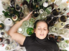 Young woman in depression, drinking alcohol
