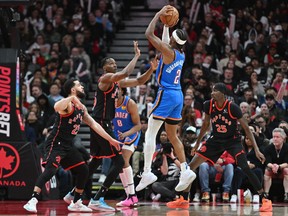 Oklahoma City Thunder guard Shai Gilgeous-Alexander (2) shoots the ball over Toronto Raptors center Christian Koloko (35) and guard Fred VanVleet (23) in the second half at Scotiabank Arena March 16, 2023. Dan Hamilton-USA TODAY Sports