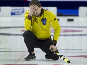Manitoba's Matt Dunstone holds his head after missing his last shot in the Page playoff 1-2 game at the Tim Hortons Brier on Saturday.