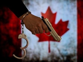 A person holding a handgun is pictured in this photo illustration.