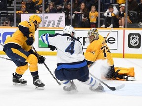 Jets defenceman Neal Pionk scores the overtime winning goal on a feed from teammate Pierre-Luc Dubois on Saturday in Nashville.