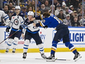 Jets winger Nikolaj Ehlers takes a punch from Blues winger Brayden Schenn during a second-period fight.